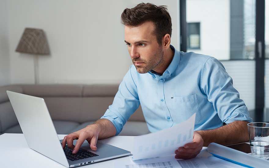 man using a laptop for online personal banking