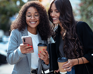 Two women looking at a mobile phone